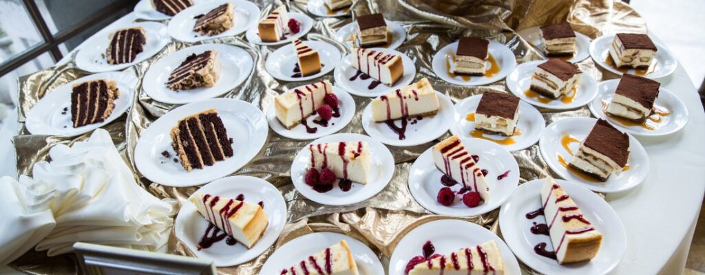A variety of wedding cake pieces on plates. This is for the article called wedding expenses you can avoid
