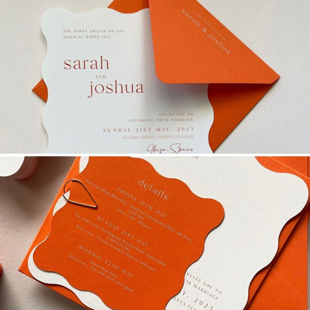 A close up photos of an orange wedding invitation suite