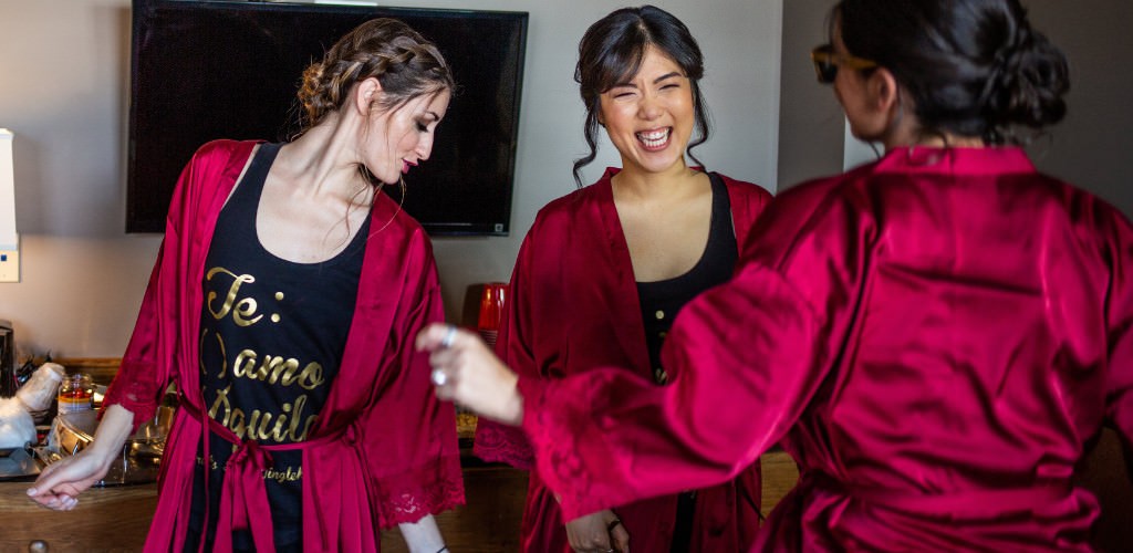 3 bridesmaids dancing in the getting ready suite on the morning of the wedding