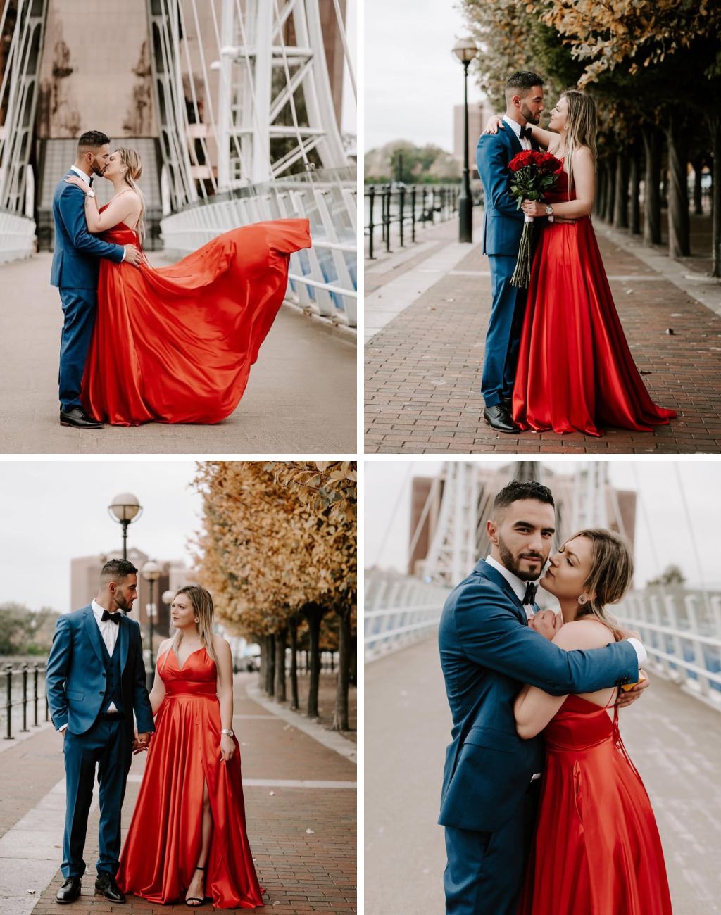A couple posing outside for engagement photos. The girl is wearing a bright red dress and the guy is wearing a stylish  dark blue suit.