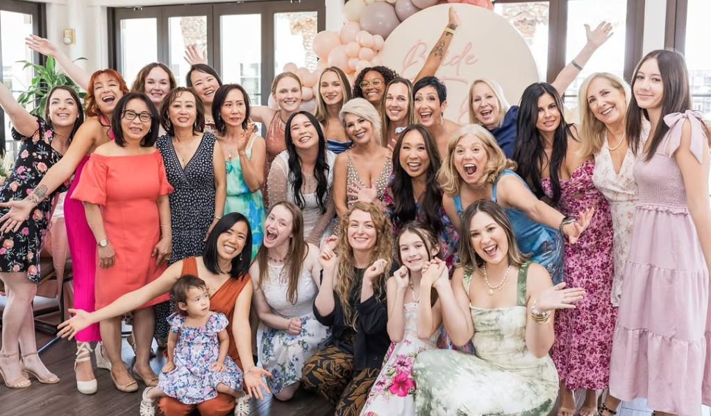 A bridal shower with lots of guests posing for a photo