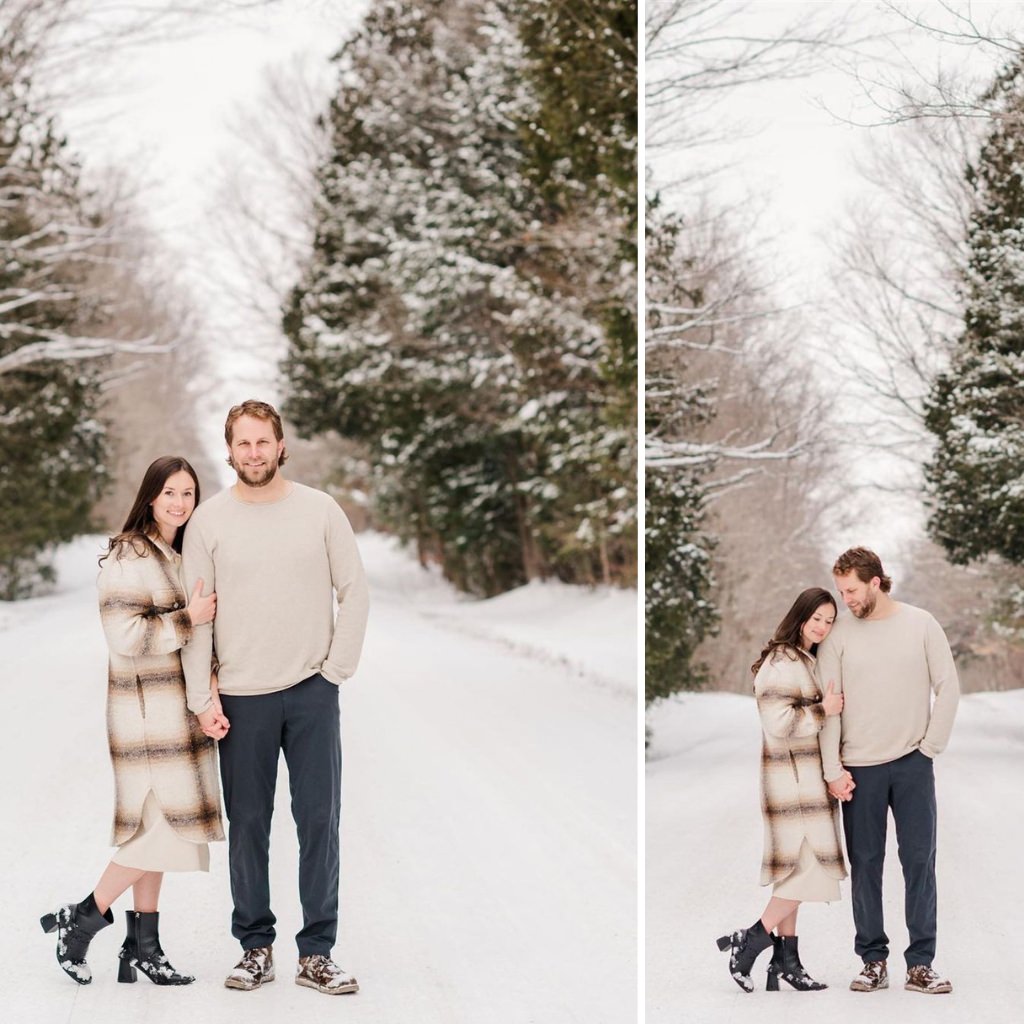 A couple posing for winter engagement photos in the snow wearing stylish outfits