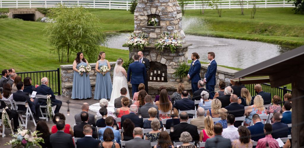 A beautiful outdoor wedding ceremony taking place at a venue in PA.