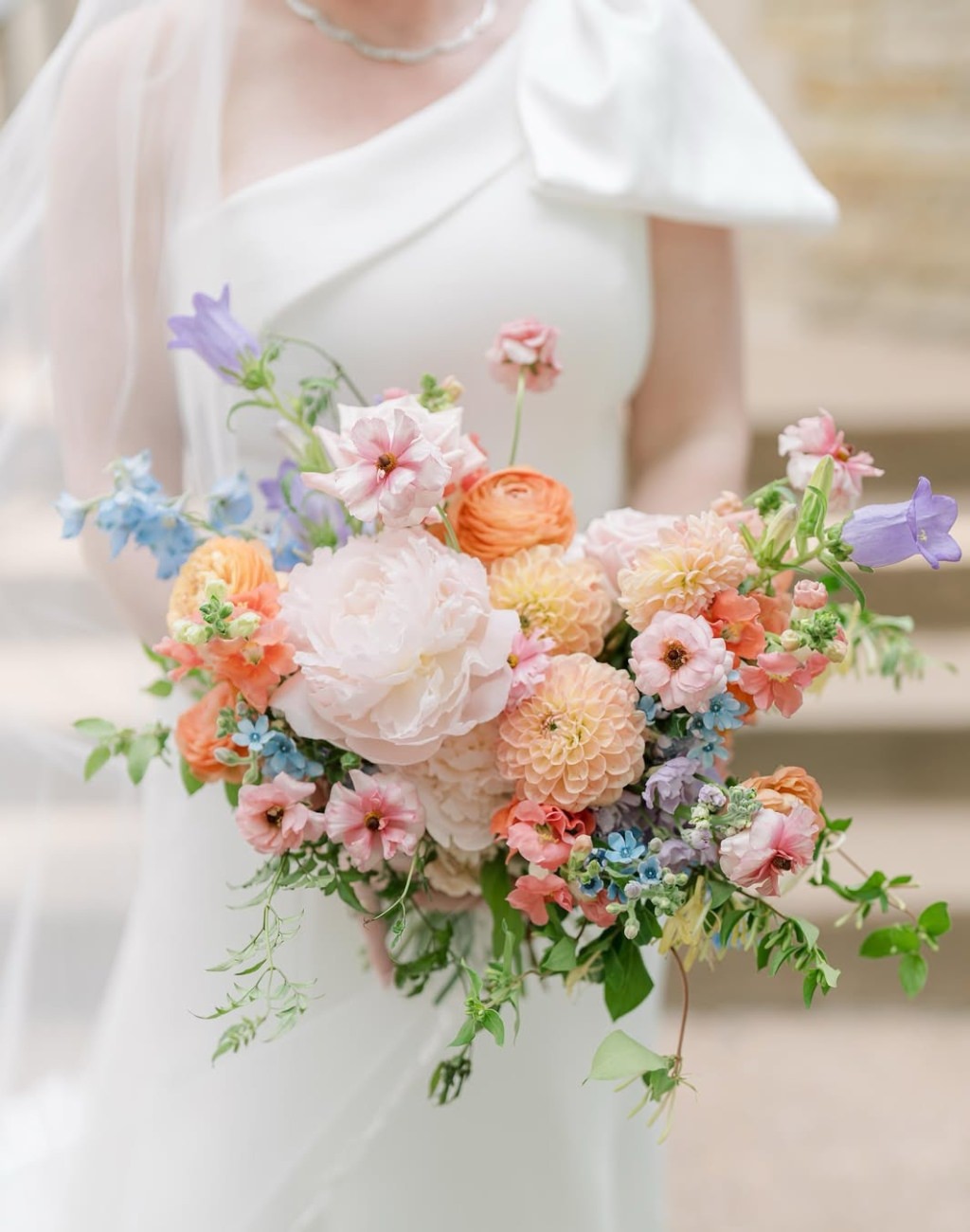 A beautiful spring wedding bouquet with lavender, blush, pink, and peach colored flowers