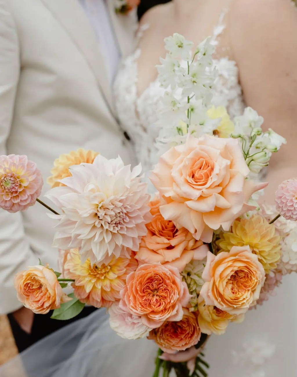 A beautiful photo of a bride's wedding bouquet with peach colored flowers